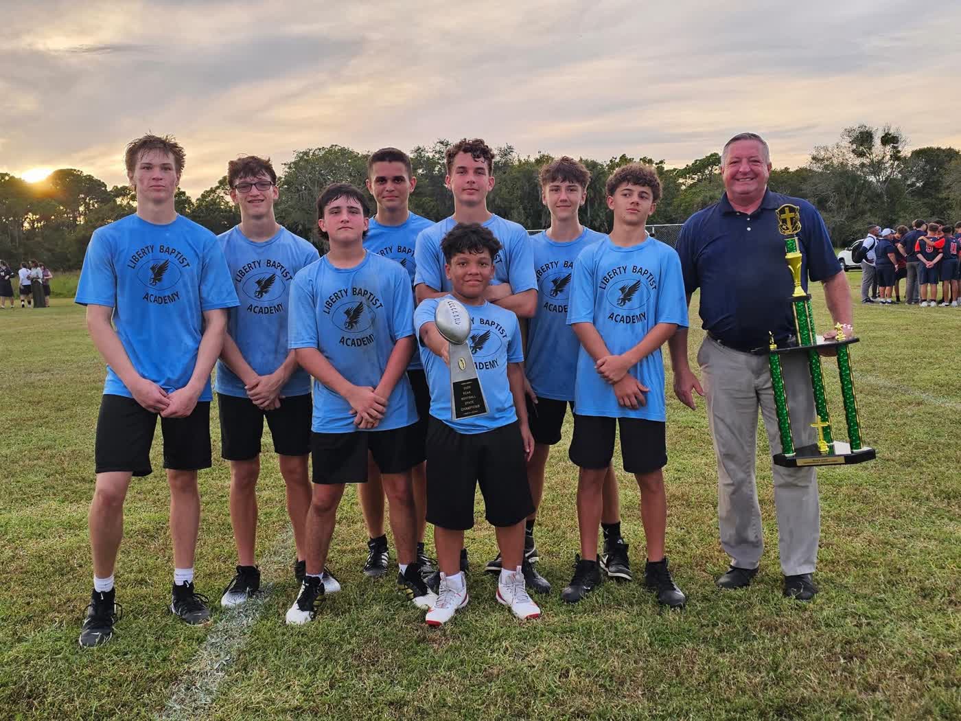 Liberty Baptist Academy Hawks players with trophies